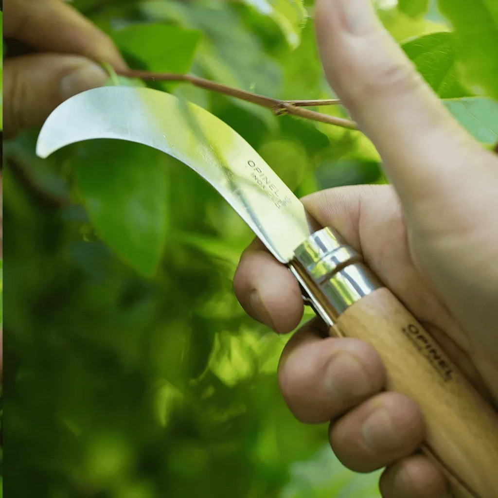 Opinel 10 billhook pruning knife with blurred green nature background on  Homestead Iron site