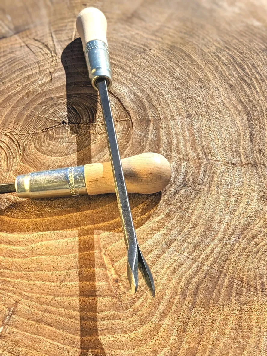 Weeding Fork (dandelion fork) Hand Forged Garden Tool Homestead Iron on wooden background point sharp out